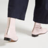 Ops&Ops No12 Pink Frost leather go-go boots, worn with cropped navy trousers close-up of zips