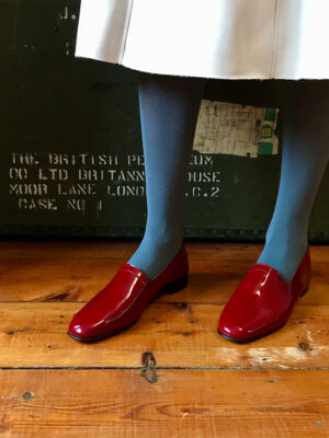 No11 Crimson patent leather loafers paired with petrol blue tights and cream leather skirt