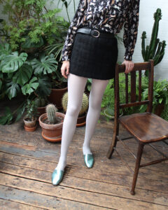 No13 Metallic Mint slides paired with white tights and black mini