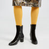 Marla in Ops&Ops No16 Classic Black Duo boots, gold-coloured tights and Karen Millen animal print sequinned skirt