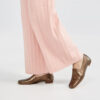Teri wears Ops&Ops No17 Bronze metallic leather loafers worn with pink pleated wool trousers