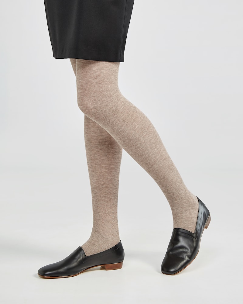 Marla in Ops&Ops No17 Classic Black flats with oatmeal tights and above-the-knee black skirt from the side