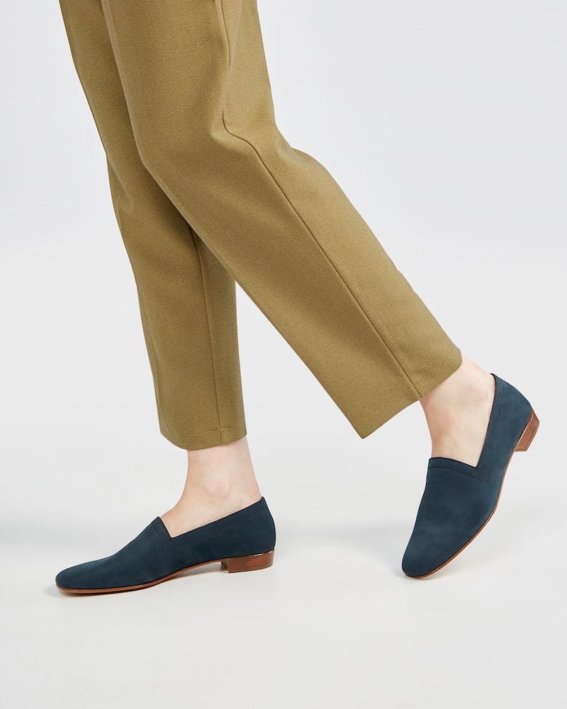 Marla in Ops&Ops No17 Petrol nubuck flats with fawn-coloured trousers from the side