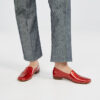Ops&Ops No17 Ruby patent leather loafers worn with dark-denim jeans, side shot of left foot