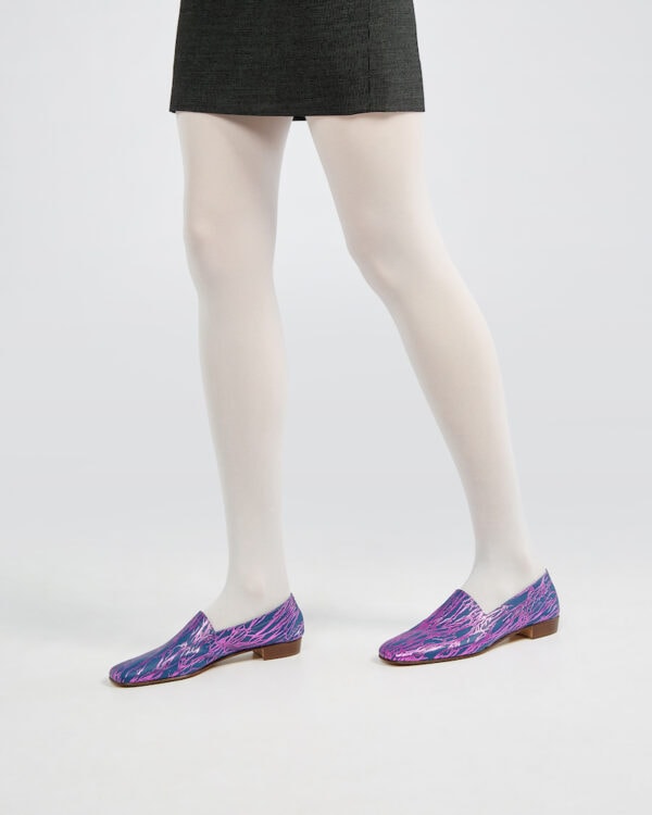 Marla in Ops&Ops No17 Woodland Blue flats with white tights and black short skirt from the side