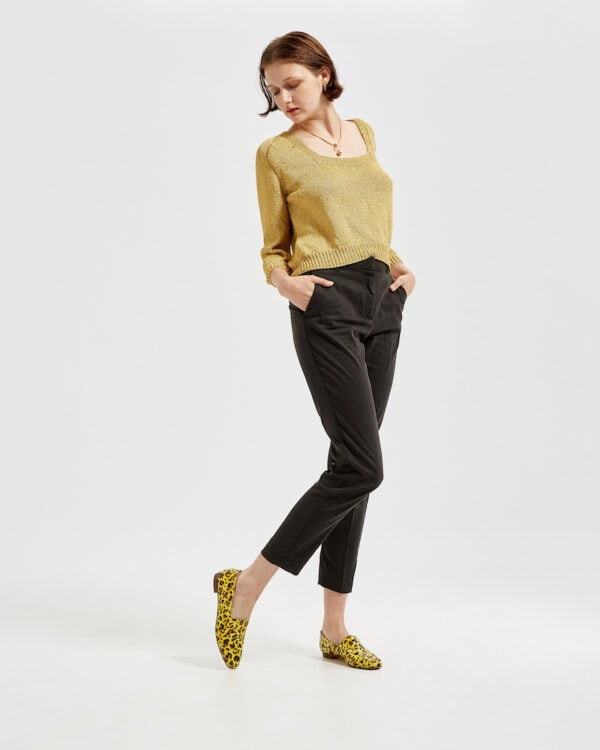 Marla standing in Ops&Ops No10 Leopard print patent flats with gold knitted sweater and black cropped trousers