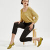 Marla in Ops&Ops No10 Leopard print patent flats with gold knitted sweater and black cropped trousers sitting on stool