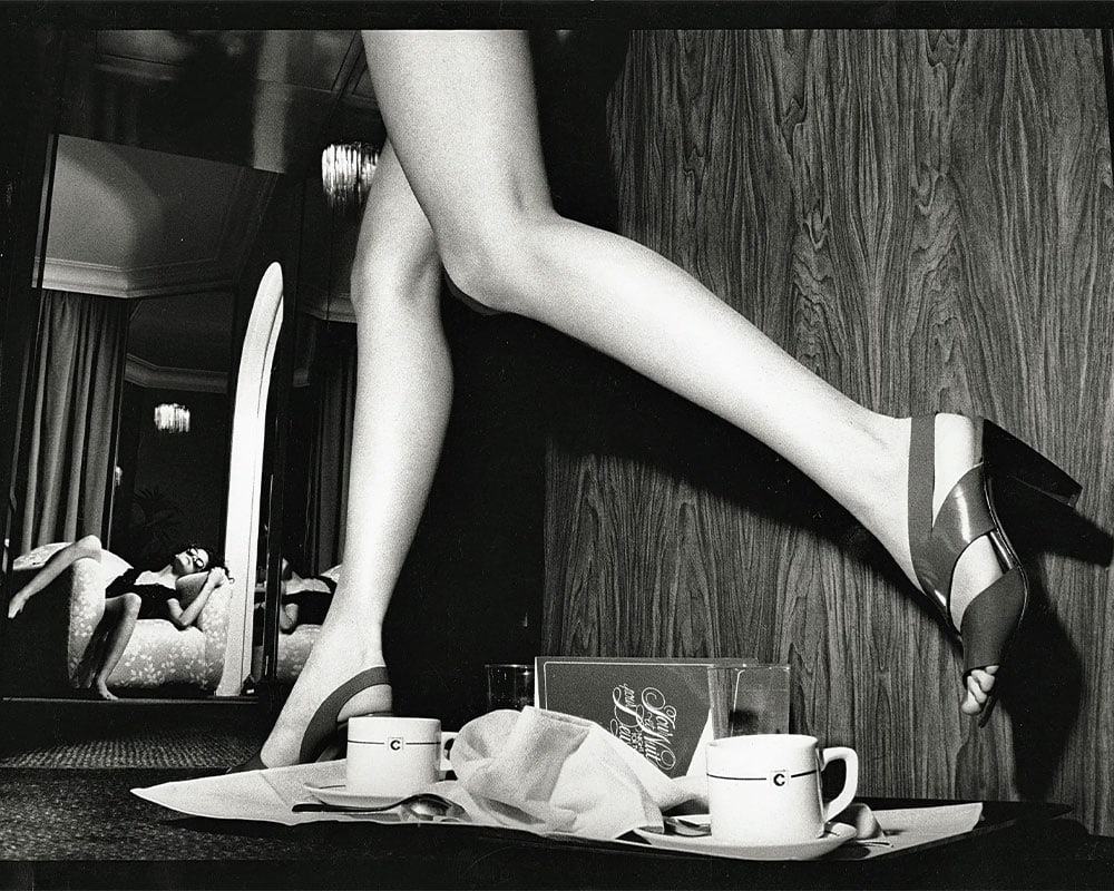 Guy Bourdin Vogue Paris 85. Legs stepping over a tray