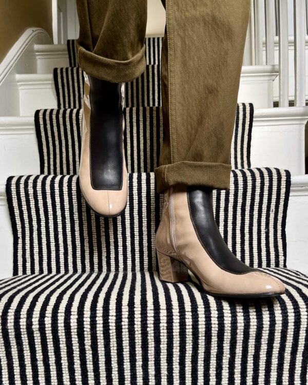 Ops&Ops No16 Sandstone Patent Leather block-heel boots worn with olive green trousers and posed on stairs with striped carpet