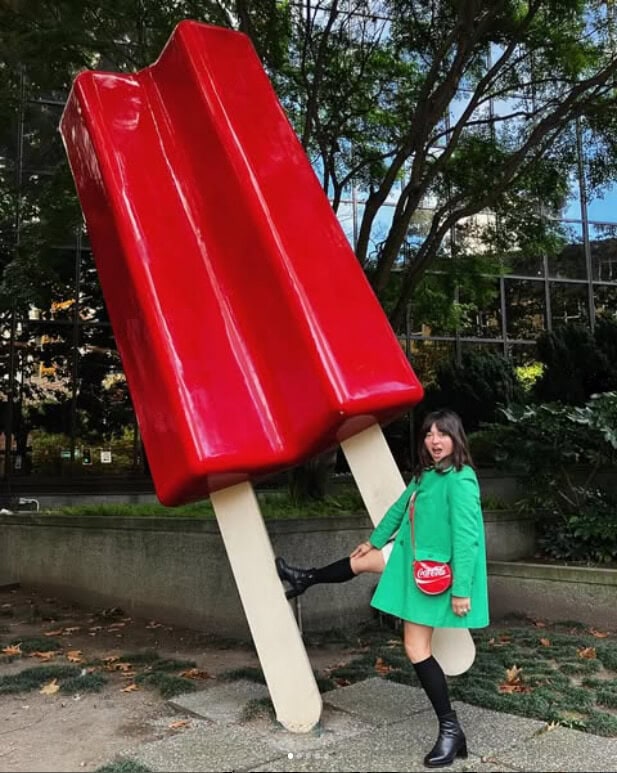 Vintage boutique Tops of the Shop boutique owner with Seattle's red popsicle art installation