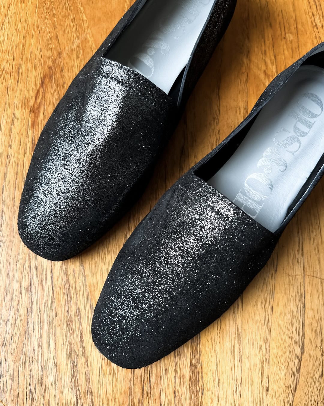 Ops&Ops No10 Lurex Black flats still on wooden table