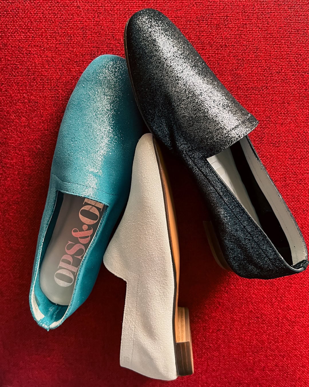 777AF55E-D646-4506-94CC-B52707A587E9 Ops&Ops No10 flats in Lurex Blue, Lurex White, Lurex Black on a red background